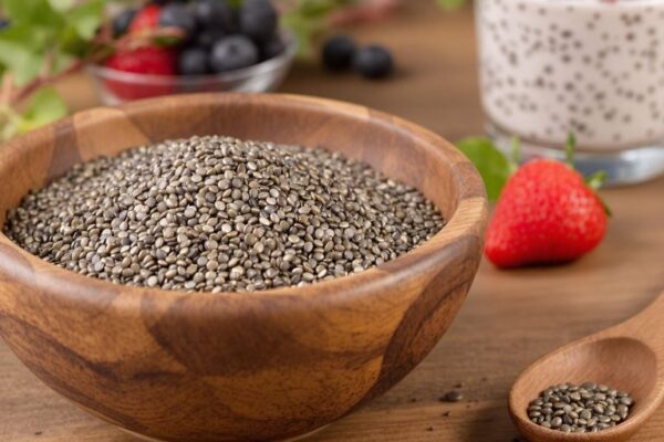 Bowl of chia seeds with spoon and chia pudding