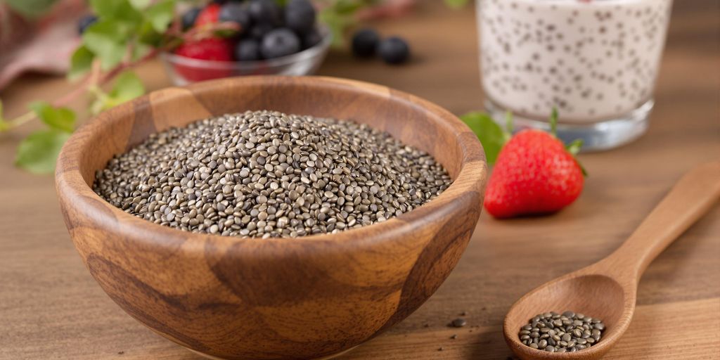 Bowl of chia seeds with spoon and chia pudding