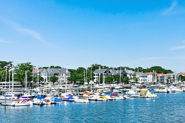 Colorful boats in Rhode Island harbor and colonial buildings.