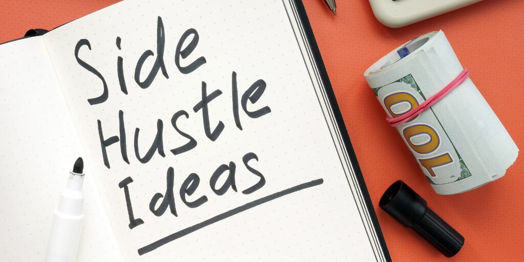Notebook with "Side Hustle Ideas" and cash beside it.