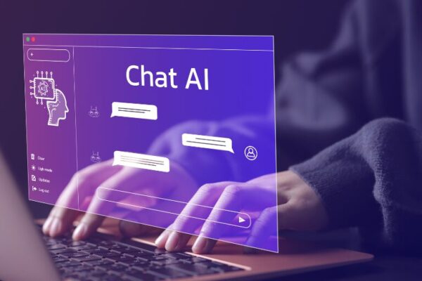Person typing on a laptop with a transparent virtual interface displaying a chatbot labeled "Chat AI" and digital conversation bubbles.