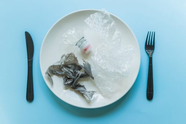 plastic on a plate with fork and knife on side of plate