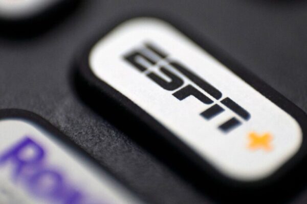 Close-up of a TV remote button featuring the ESPN+ logo, highlighting the streaming service option