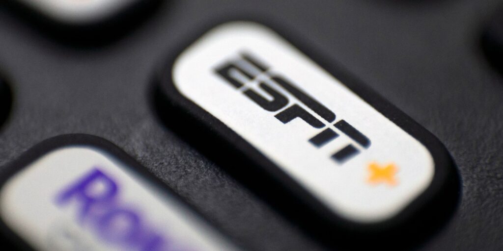 Close-up of a TV remote button featuring the ESPN+ logo, highlighting the streaming service option