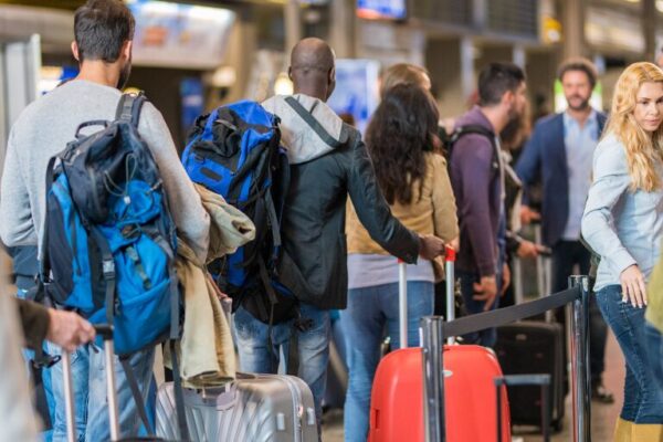 people standing in line at busy airport