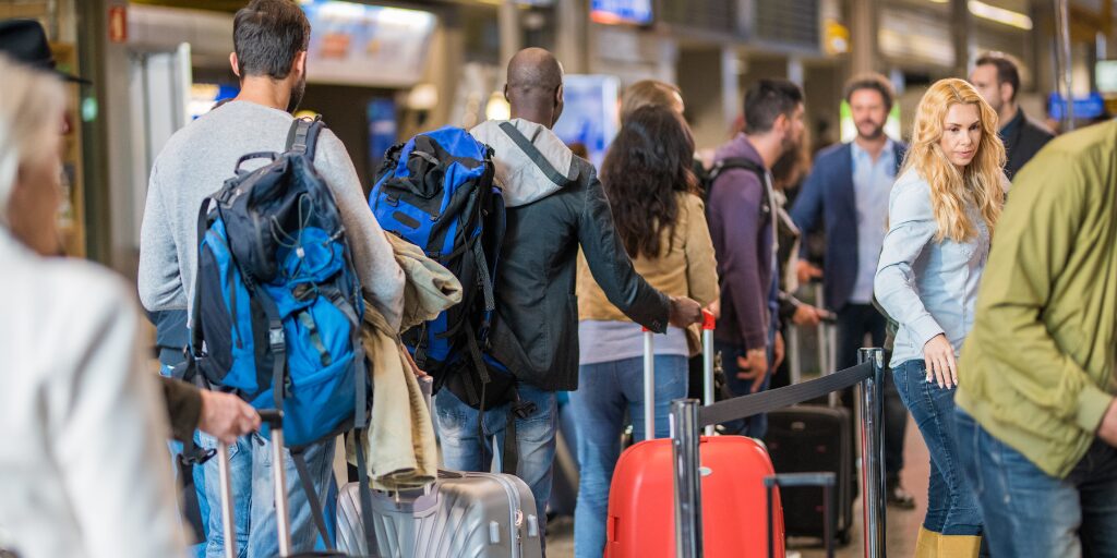 people standing in line at busy airport