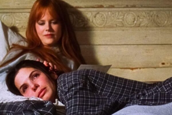 Sandra Bullock and Nicole Kidman in bed during the movie Practical Magic.