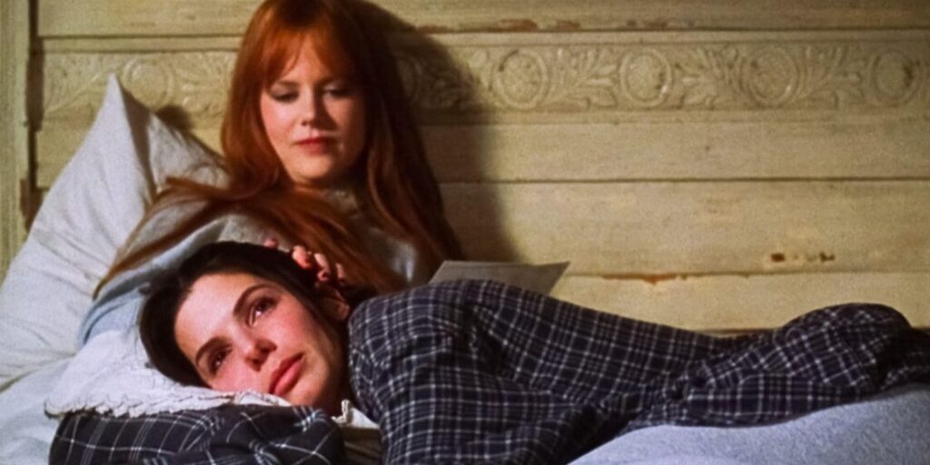 Sandra Bullock and Nicole Kidman in bed during the movie Practical Magic.