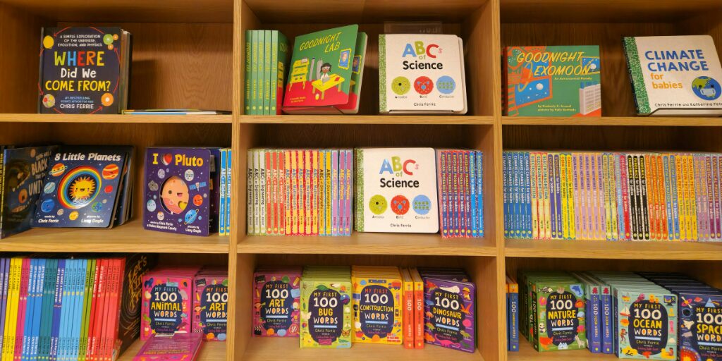 Children's books on a shelf in a library.
